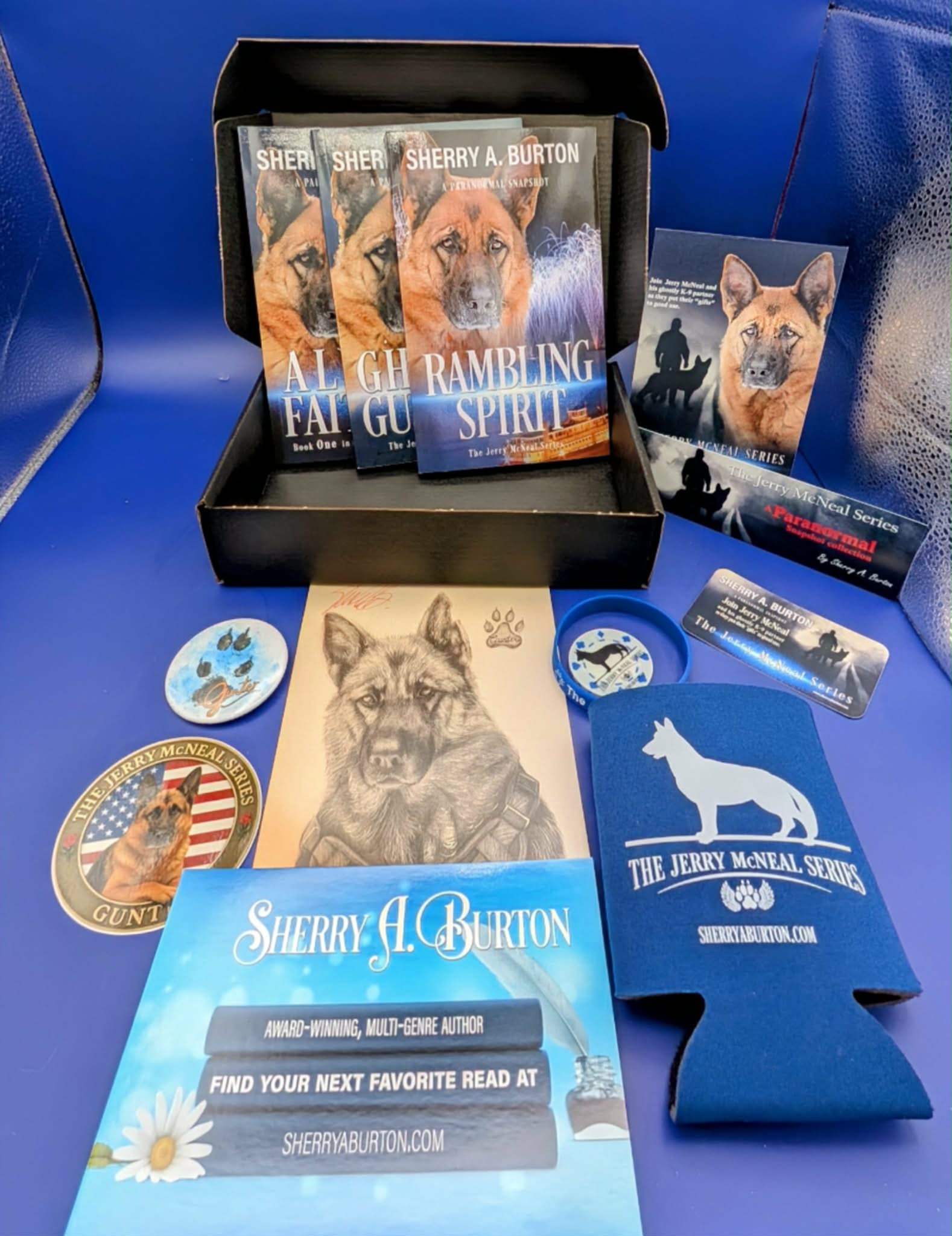 Collection of Sherry A. Burton book covers and promotional items on a blue surface